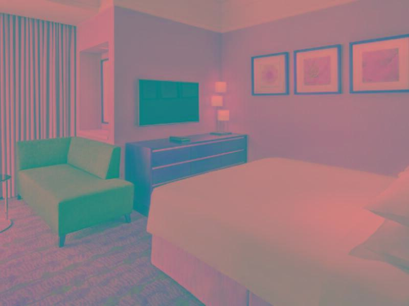 Jabal Omar Hyatt Regency Makkah Hotel Mecca Exterior photo The photo shows a hotel room featuring a comfortable setting. There is a large bed with white linens, positioned next to a stylish dresser. A flat-screen television is mounted on the wall opposite the bed. To one side, there is a small green sofa and